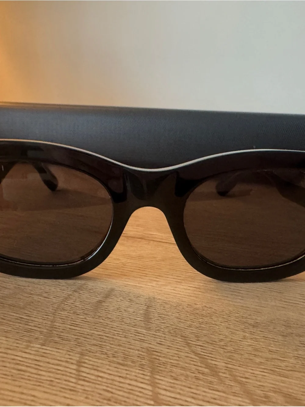 Gucci Glossy Black Oval Sunglasses with Dark Lenses